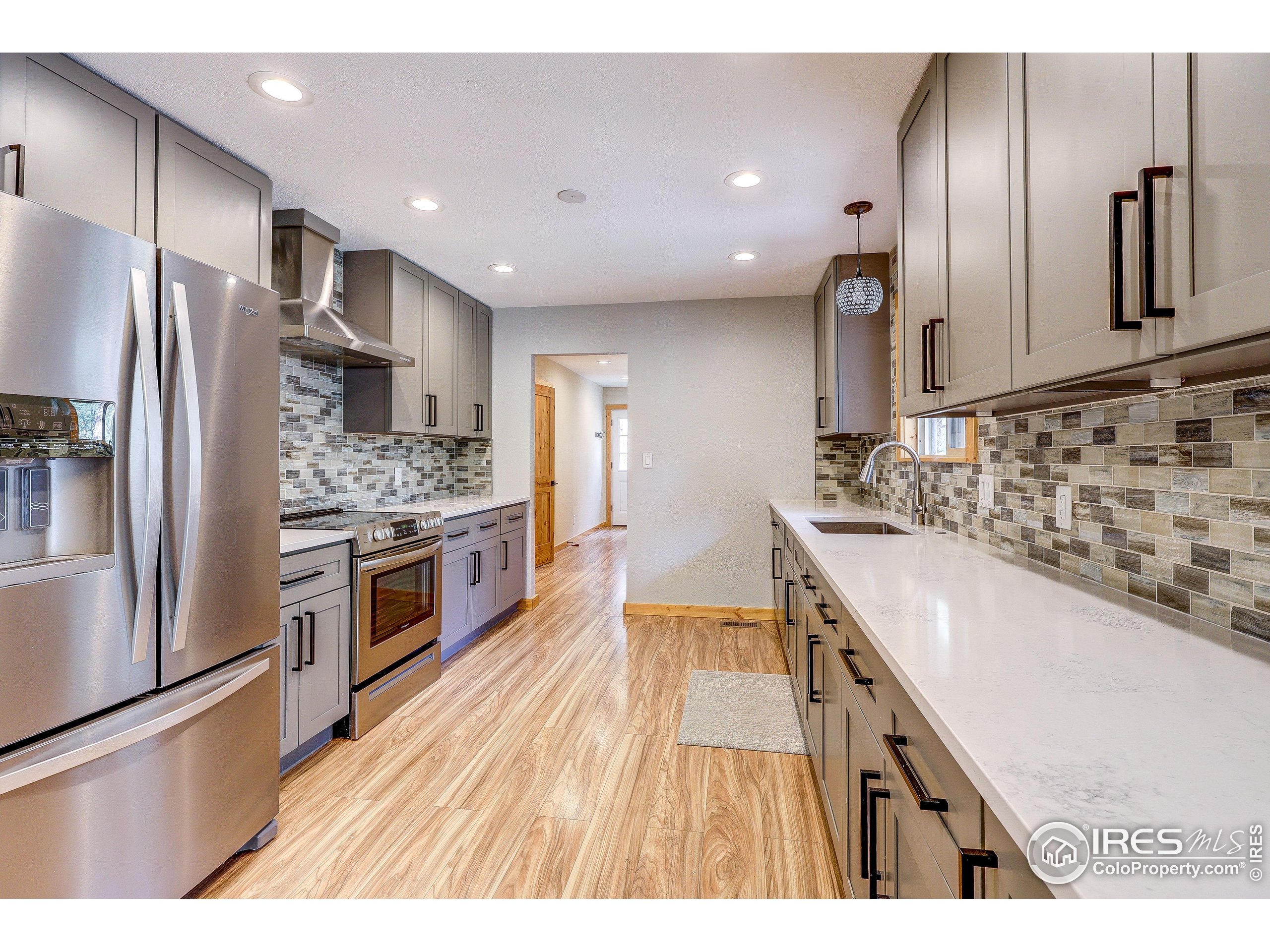 166 Cherokee Road Lyons, CO 80540 - Photo 11 of 38 a kitchen with stainless steel appliances granite countertop a sink stove and refrigerator