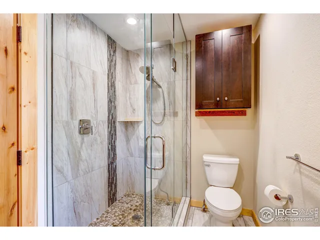 a bathroom with a glass shower door