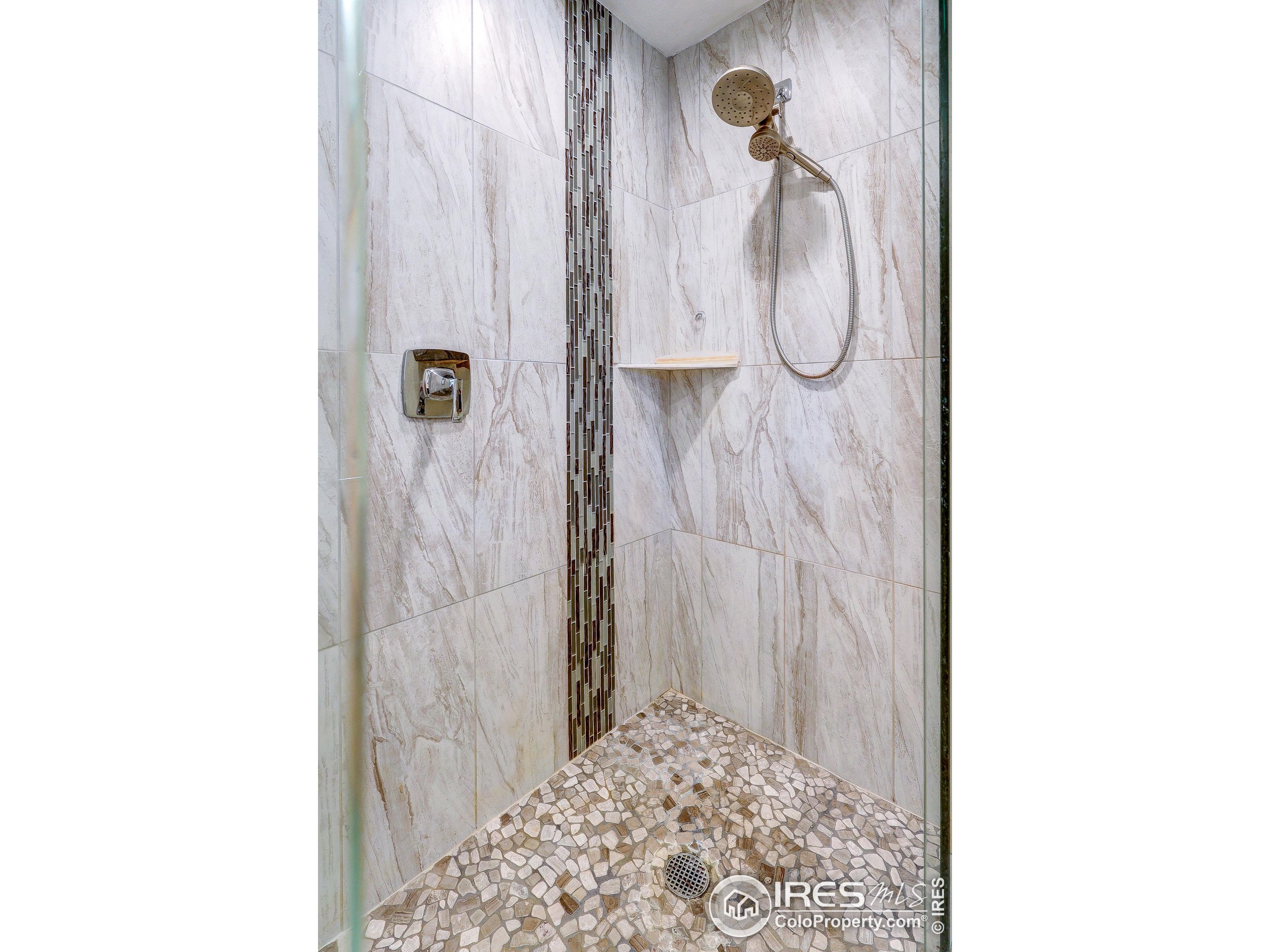 166 Cherokee Road Lyons, CO 80540 - Photo 20 of 38 a bathroom with a glass shower door