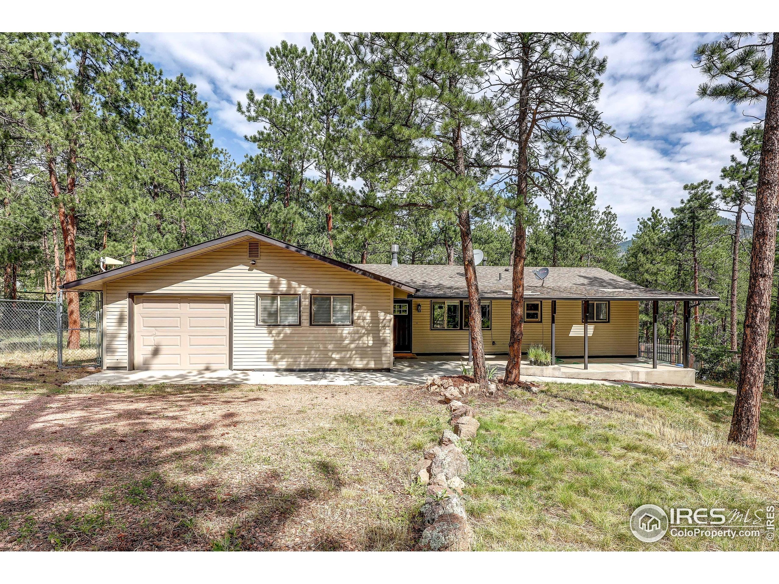 166 Cherokee Road Lyons, CO 80540 - Photo 2 of 38 a house with trees in the background