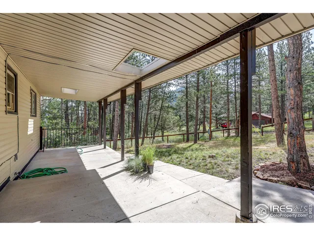 a view of a porch with furniture and garden