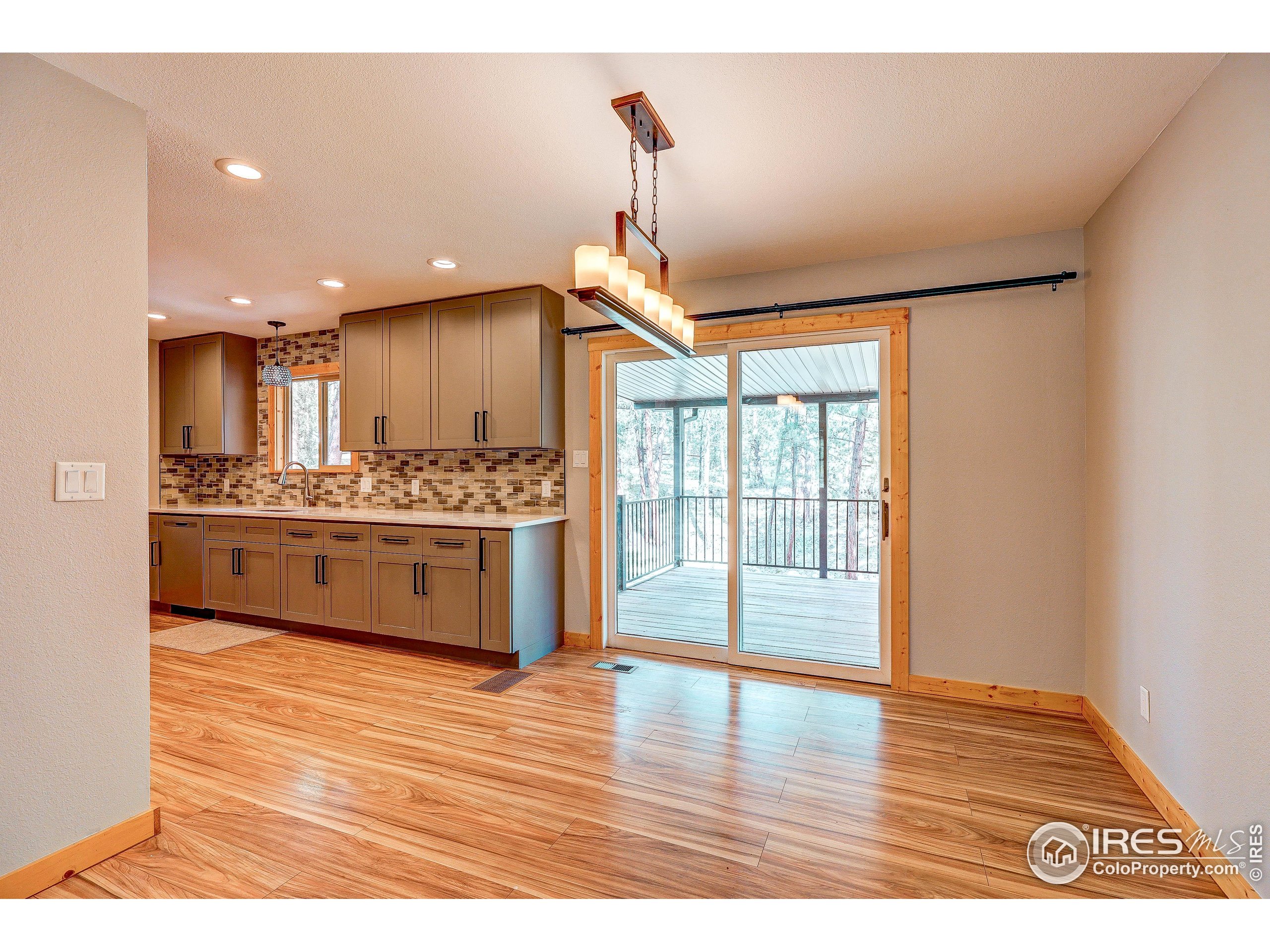 166 Cherokee Road Lyons, CO 80540 - Photo 8 of 38 a view of kitchen with kitchen island stainless steel appliances wooden floor and window