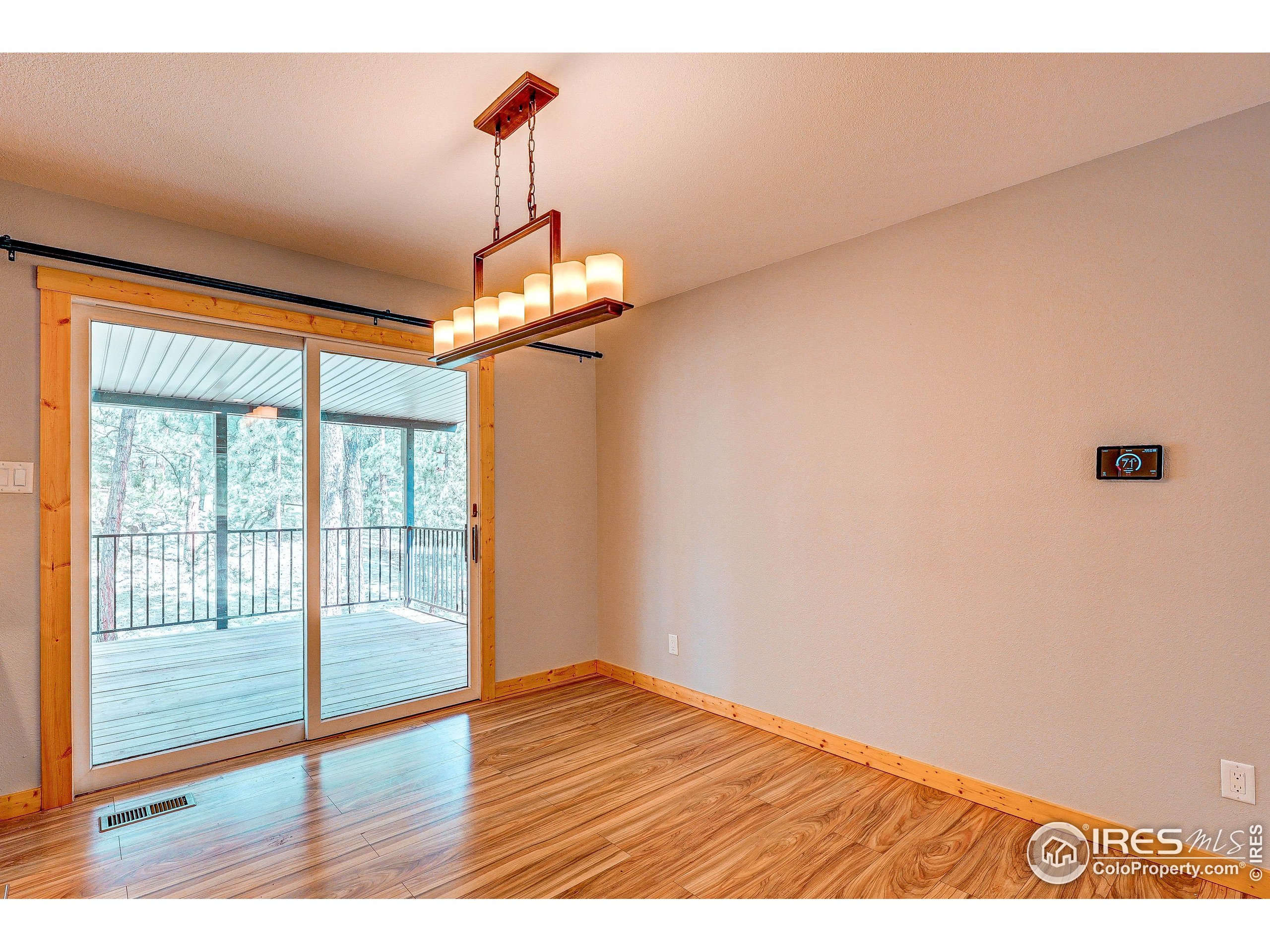 166 Cherokee Road Lyons, CO 80540 - Photo 9 of 38 a view of empty room with wooden floor and fan