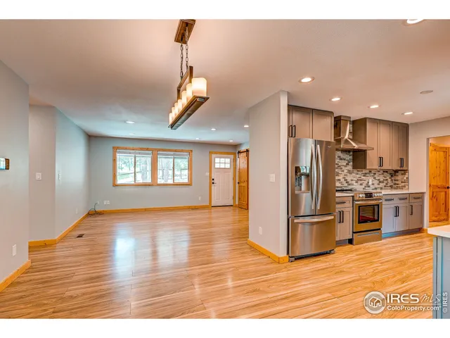 a spacious bathroom with a sink a mirror and a shower