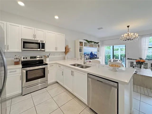 a kitchen with sink a microwave and cabinets