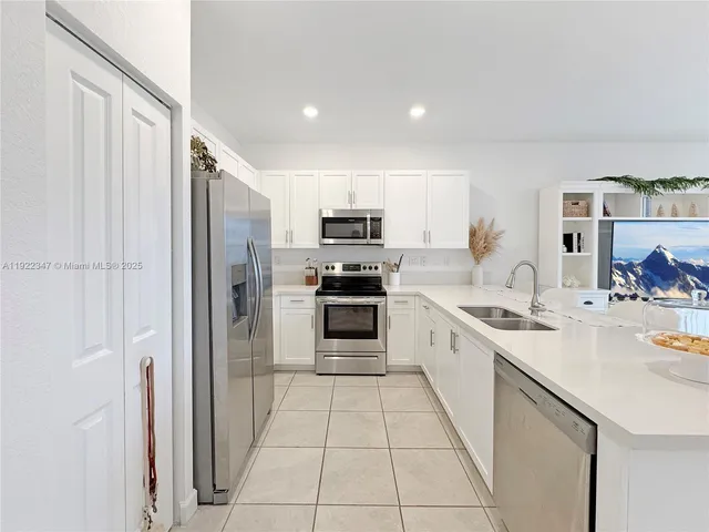 a large kitchen with a stove top oven and cabinets
