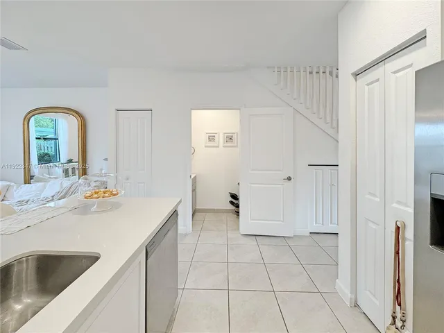 a view of a patio with table and chairs with wooden fence and plants