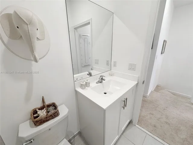 a aerial view of a house with table and chairs under an umbrella