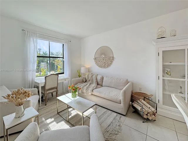 a living room with furniture a window and a chandelier
