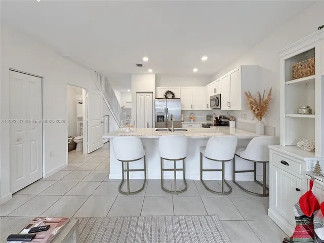 a open kitchen with stainless steel appliances kitchen island granite countertop a sink and cabinets