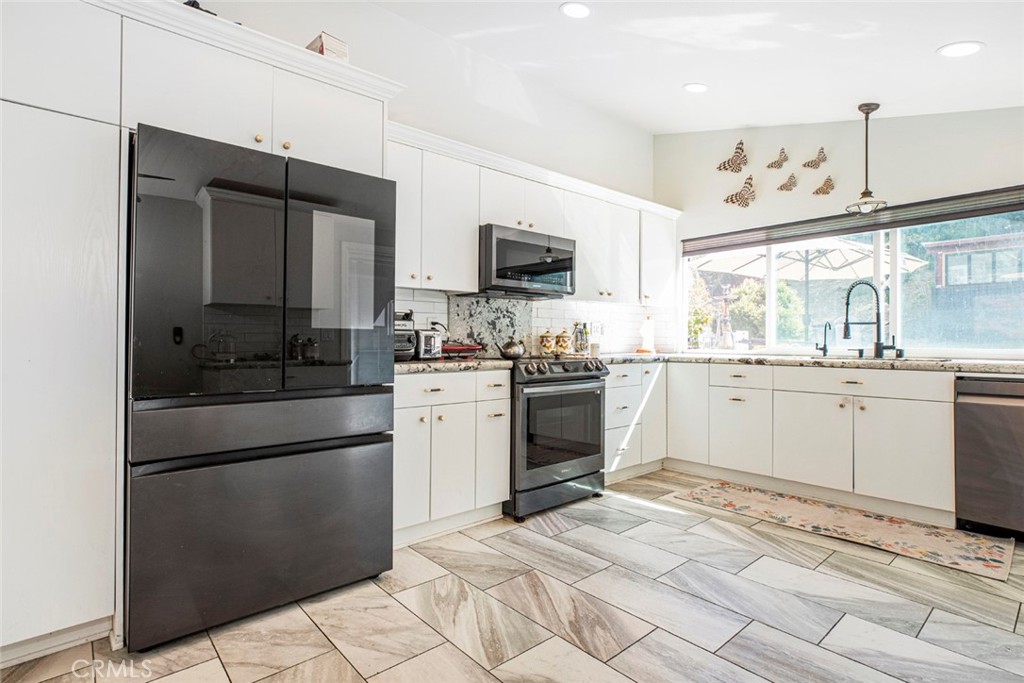 18810 Kirkcolm Lane Porter Ranch, CA 91326 - Photo 17 of 75 a kitchen with a sink stove and refrigerator