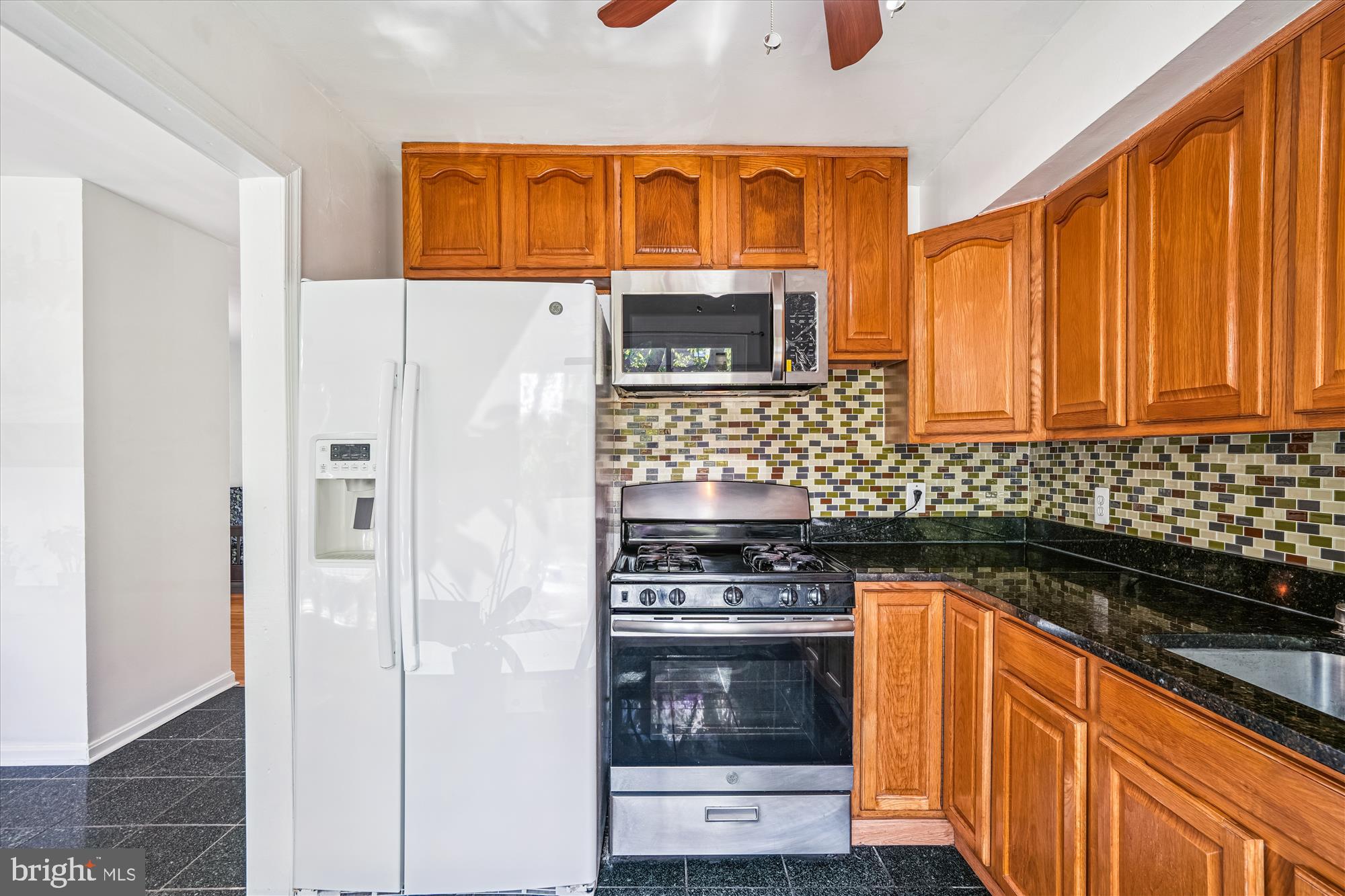 3946 Bel Pre Road, Unit 4 Silver Spring, MD 20906 - Photo 2 of 30 a kitchen with stainless steel appliances granite countertop a refrigerator and a stove