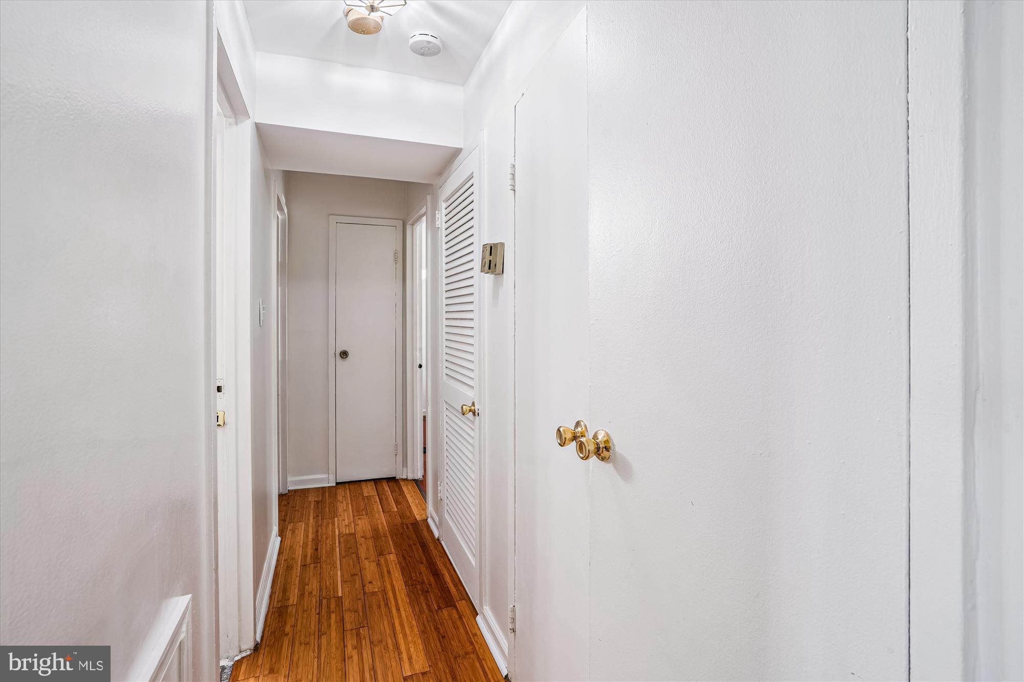 3946 Bel Pre Road, Unit 4 Silver Spring, MD 20906 - Photo 22 of 30 a view of a hallway with wooden floor and staircase