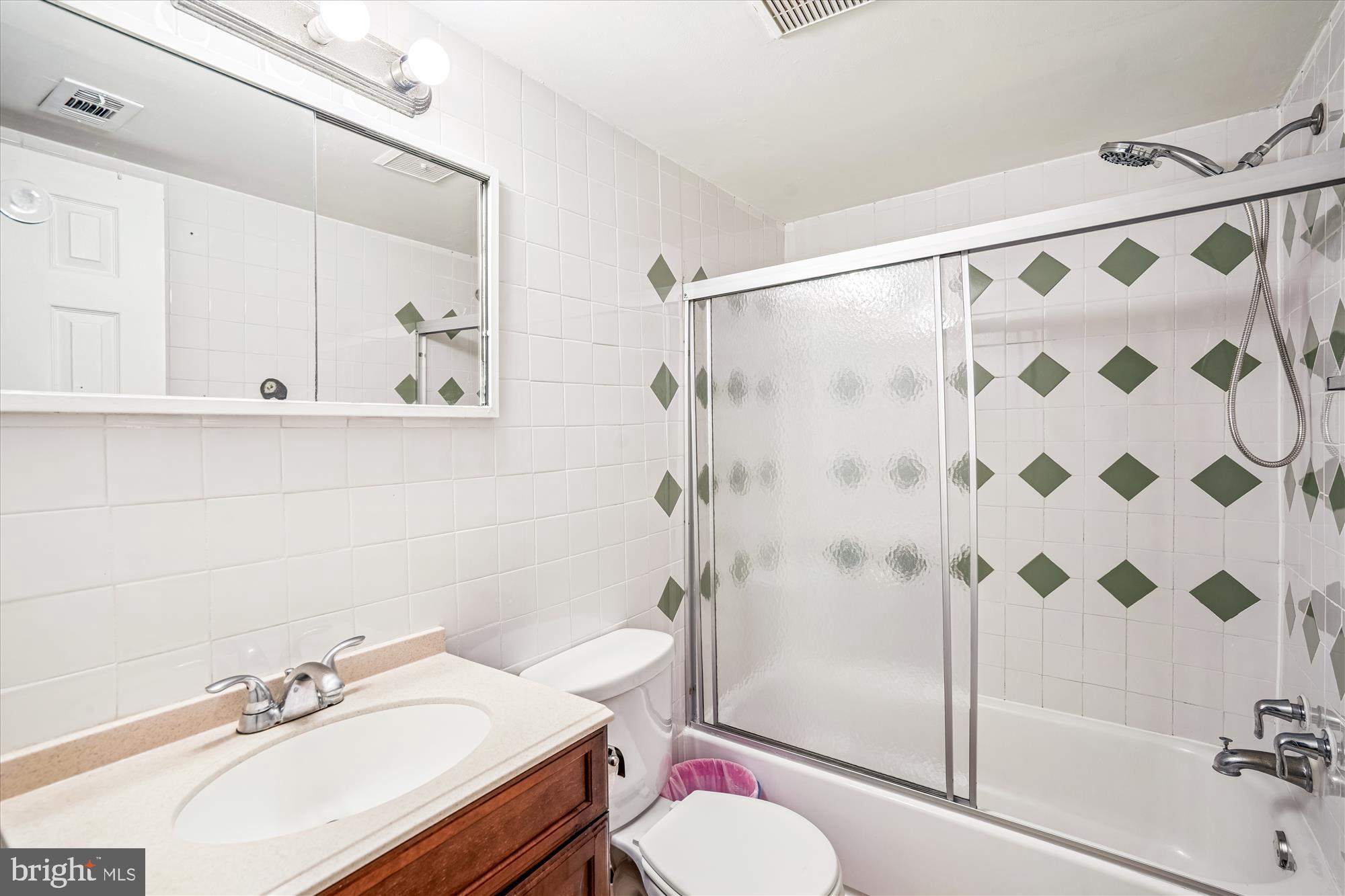 3946 Bel Pre Road, Unit 4 Silver Spring, MD 20906 - Photo 23 of 30 a bathroom with a sink toilet and shower