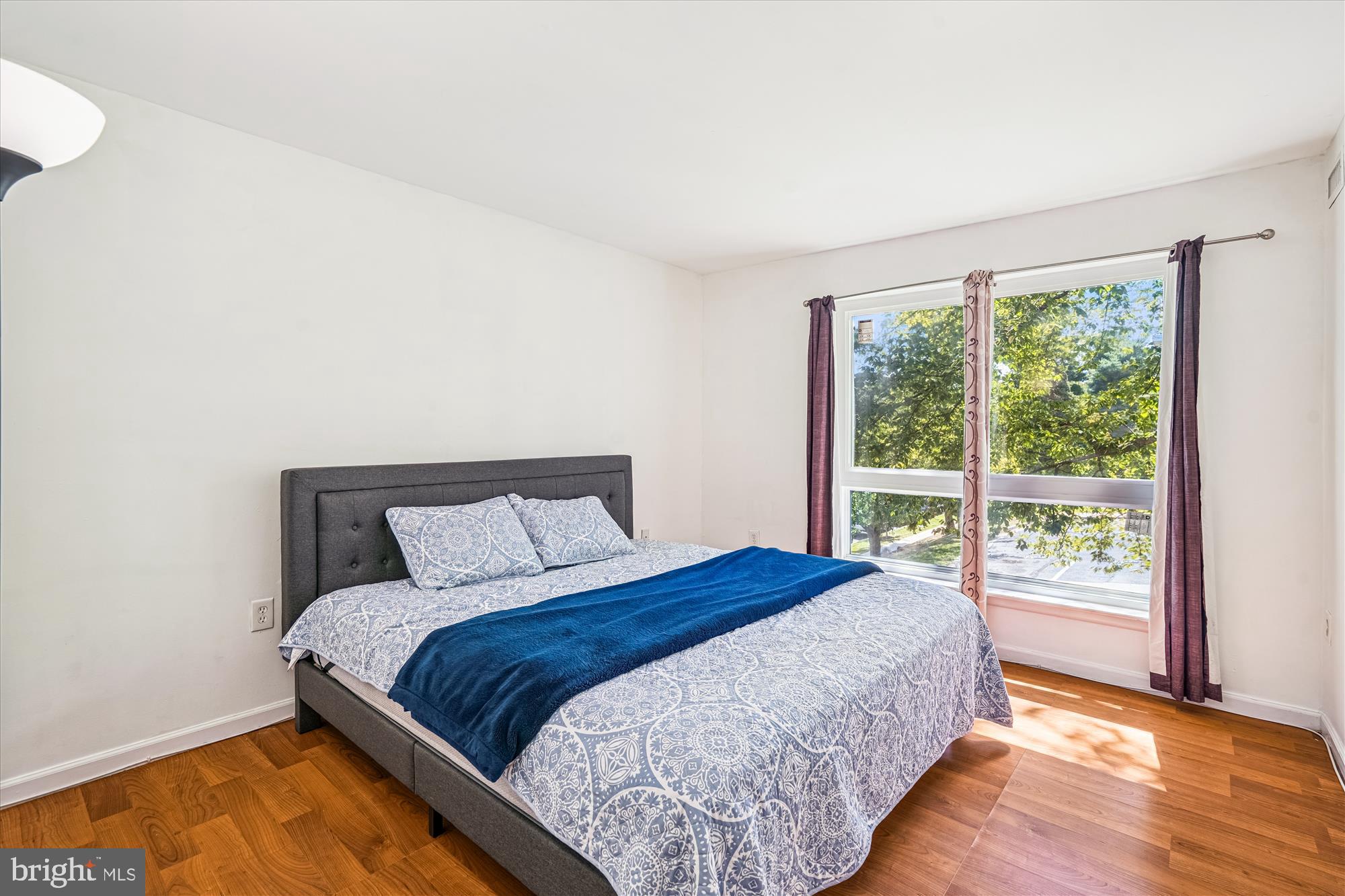 3946 Bel Pre Road, Unit 4 Silver Spring, MD 20906 - Photo 10 of 30 a bedroom with a bed and wooden floor