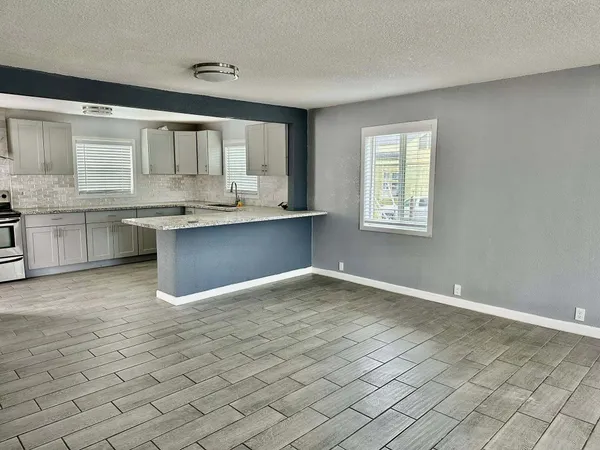 a large white kitchen with cabinets
