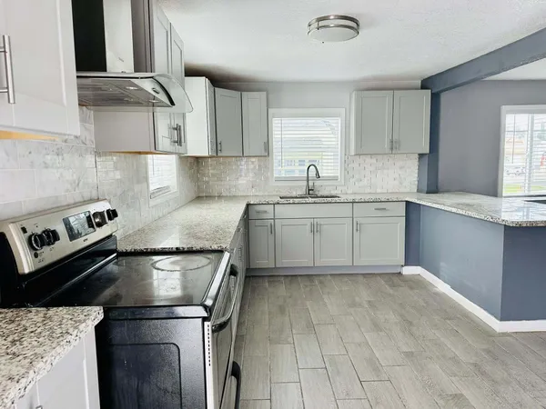 a kitchen with a sink appliances and cabinets