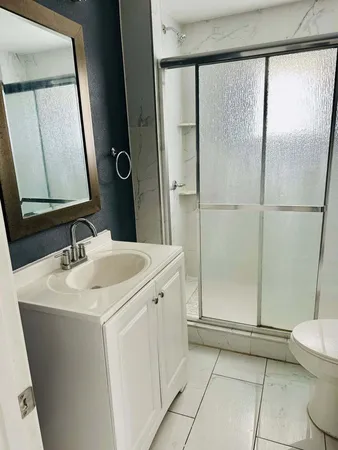 a bathroom with a sink toilet and shower