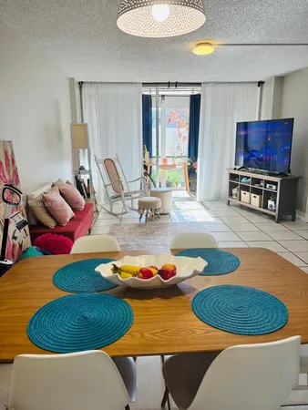 a dining room with furniture and a wooden floor