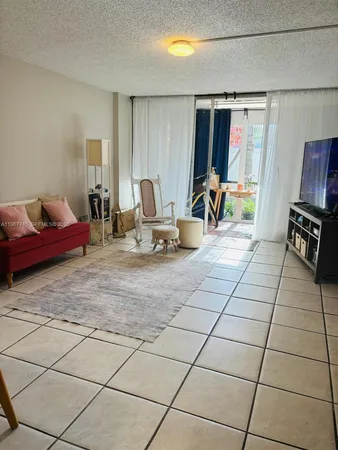 a room with gym equipment and a flat screen tv