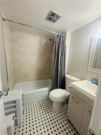 a bathroom with a sink a toilet a mirror a vanity and shower