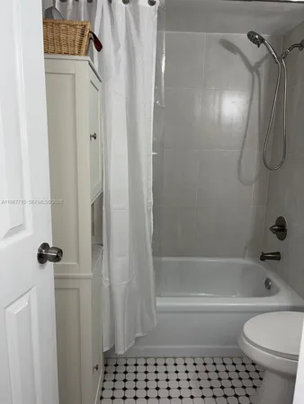 a bathroom with a shower curtain and a sink