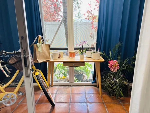 a view of an entryway with flower pots
