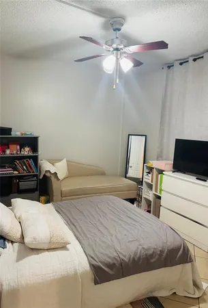 a bedroom with a bed and a television