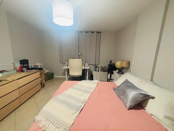 a bed room with a bed and a lamp