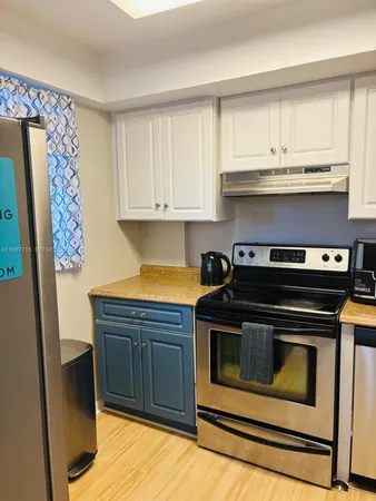 a kitchen with stainless steel appliances a stove a microwave and cabinets