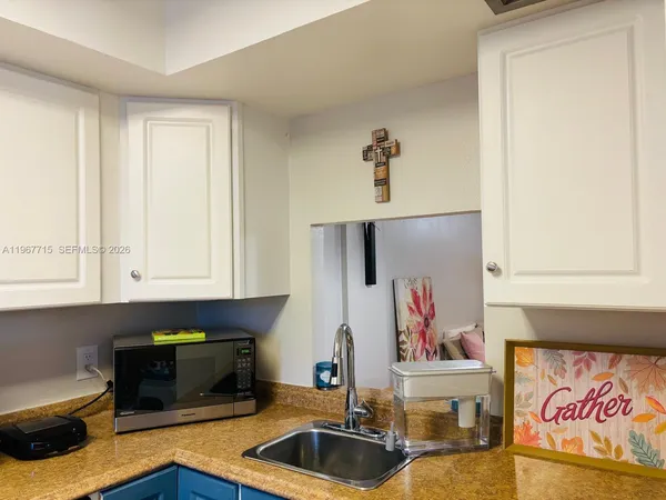 a kitchen with a refrigerator and cabinets