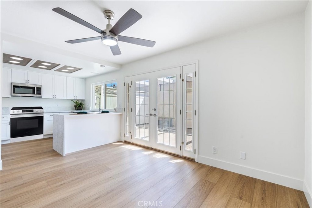 4 Wintergreen, Unit 4 Irvine, CA 92604 - Photo 11 of 39 a view of a kitchen with wooden floor and a ceiling fan