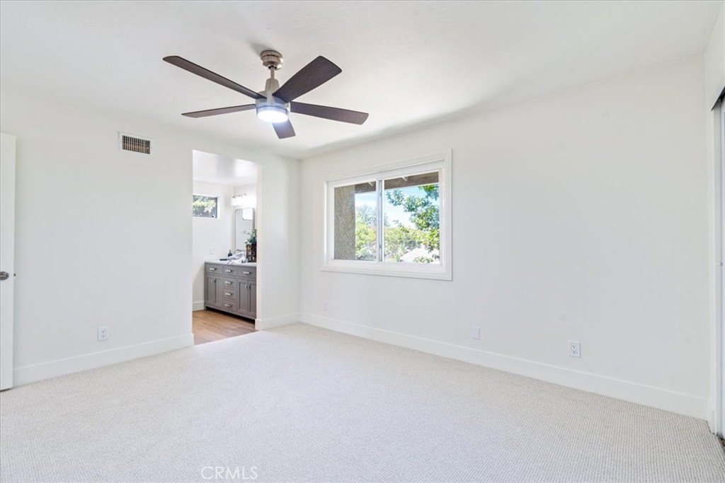4 Wintergreen, Unit 4 Irvine, CA 92604 - Photo 21 of 39 an empty room with windows and ceiling fan