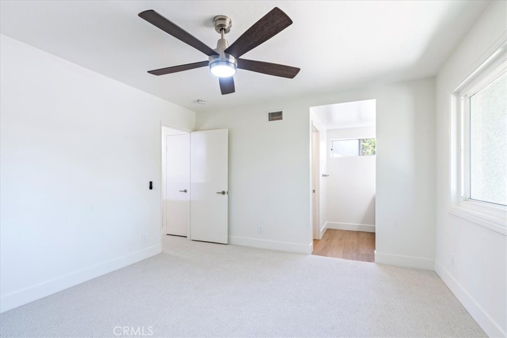 4 Wintergreen, Unit 4 Irvine, CA 92604 - Photo 24 of 39 an empty room with chandelier fan and windows