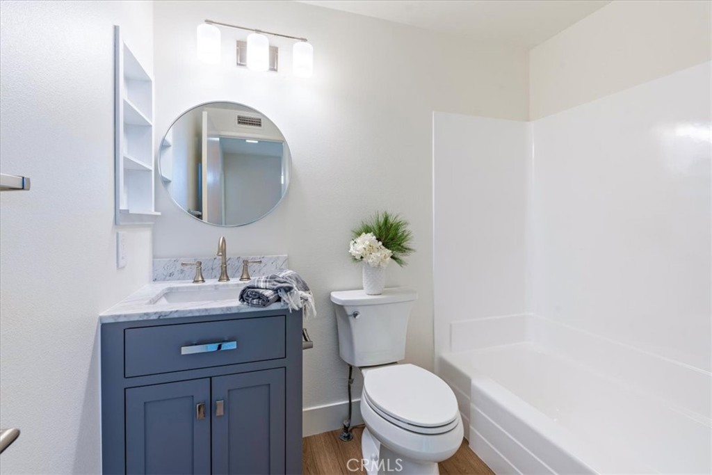 4 Wintergreen, Unit 4 Irvine, CA 92604 - Photo 26 of 39 a bathroom with a toilet sink and mirror