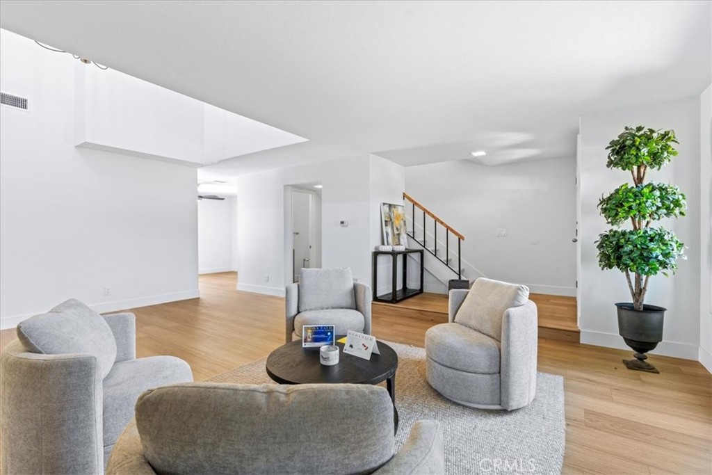 4 Wintergreen, Unit 4 Irvine, CA 92604 - Photo 3 of 39 a living room with furniture potted plant and a lamp