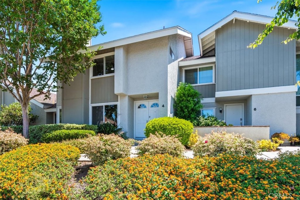 4 Wintergreen, Unit 4 Irvine, CA 92604 - Photo 32 of 39 a front view of a house with a yard