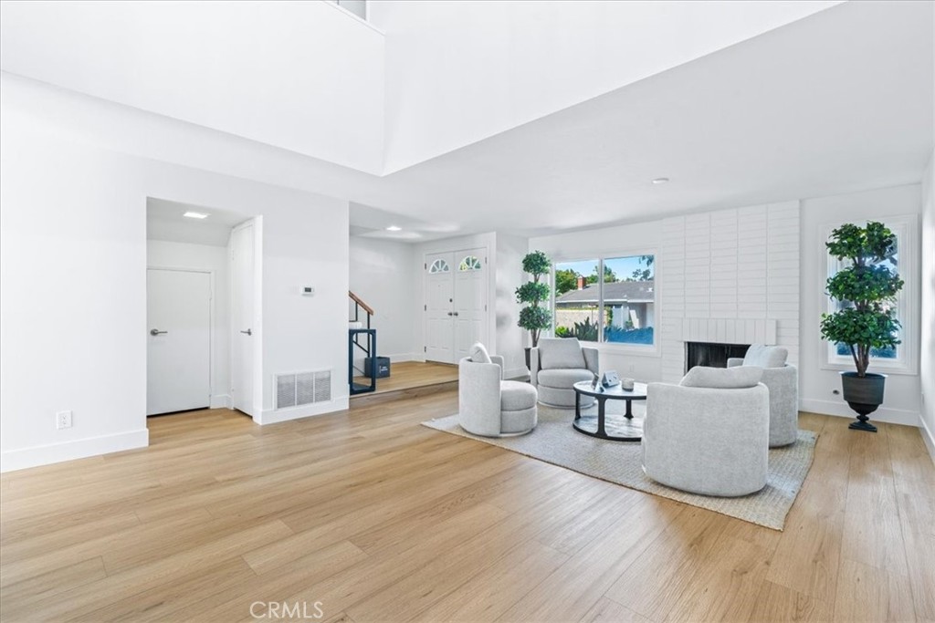 4 Wintergreen, Unit 4 Irvine, CA 92604 - Photo 4 of 39 a living room with furniture and a fireplace