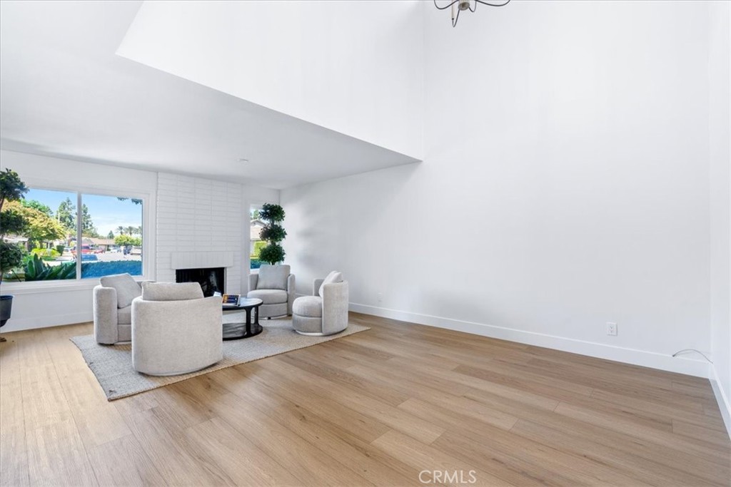 4 Wintergreen, Unit 4 Irvine, CA 92604 - Photo 6 of 39 a living room with couches and a potted plant on a dresser
