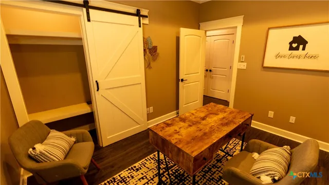 an empty room with wooden floor and closet
