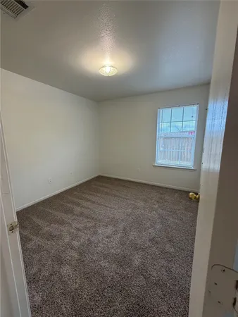 an empty room with a empty space and windows