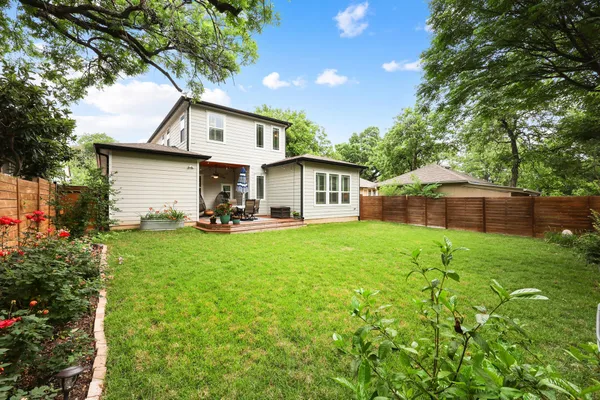 a view of yard with green space and fence