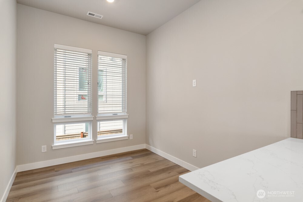 6611 South 128th Street Seattle, WA 98178 - Photo 2 of 20 a view of an empty room with wooden floor and a window