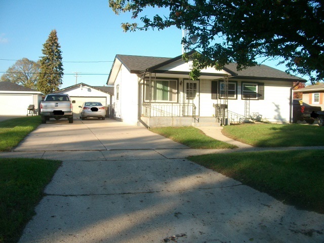 1726 85th Street Kenosha, WI 53143 - Photo 2 of 8 a front view of a house with a garden