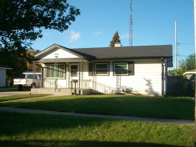 1726 85th Street Kenosha, WI 53143 - Photo 3 of 8 a front view of a house with a garden