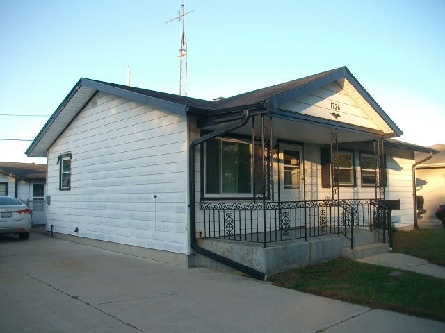 1726 85th Street Kenosha, WI 53143 - Photo 4 of 8 a view of a house with a small yard and wooden fence