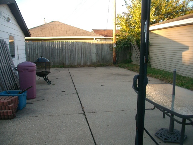 1726 85th Street Kenosha, WI 53143 - Photo 7 of 8 a backyard of a house with table and chairs