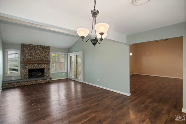 a living room with hard wood floors and a fireplace