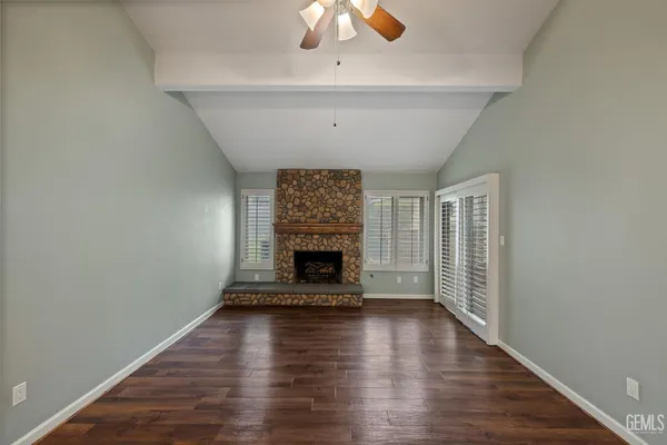 wooden floor in an empty room with a window