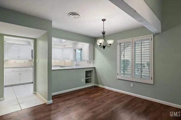 a kitchen with granite countertop a stove and a sink